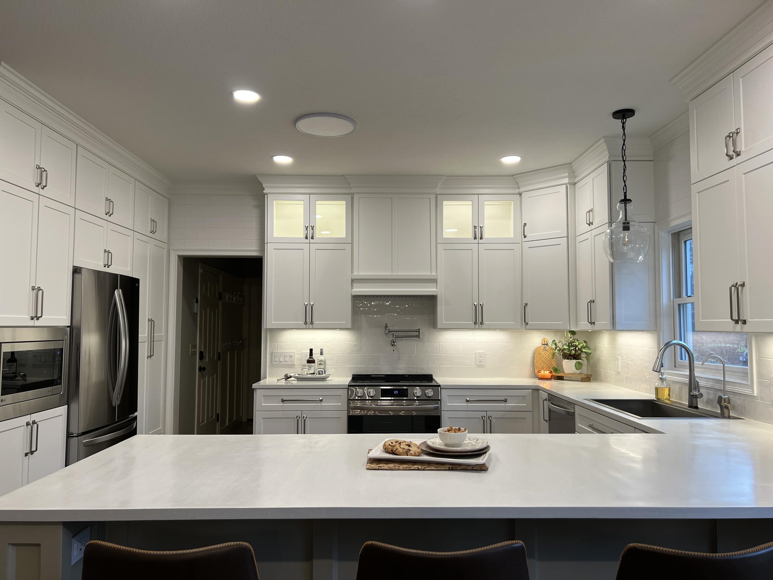 Clean, modern kitchen with white door refacing fronts.