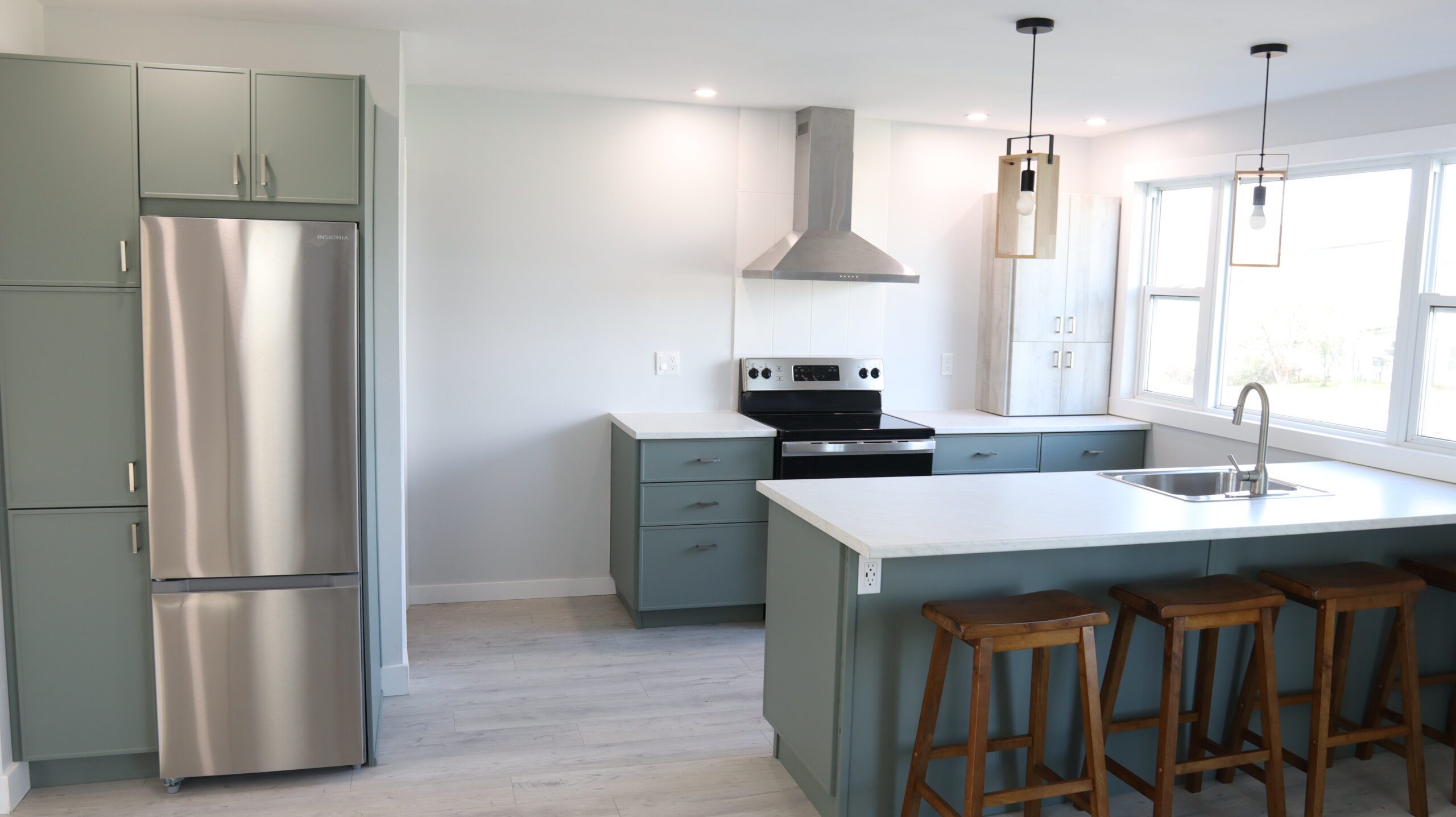 Sage green kitchen with IKEA cabinet boxes and doors from Front + Center